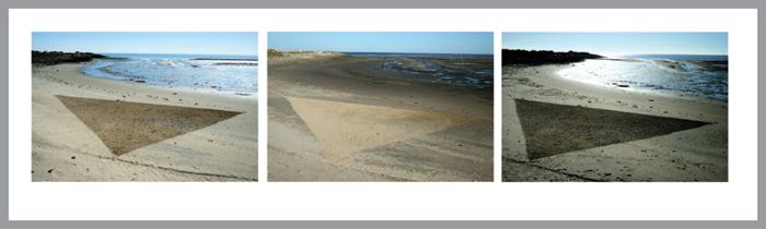 Drawing a triangle on the beach using a stick. Color changed by weather