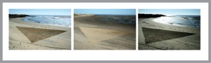 Drawing a triangle on the beach using a stick. Changing color because of changing weather